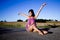 Graceful woman sits on a road.