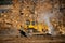 Grader excavator removes large stones after rock explosion blasting