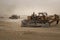 Graders at work in Sand field, excavator in land work