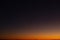 Gradient background from orange to dark blue. sunset sky over the forest, the transition from light to dark