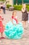 A graduate of an elementary school in a beautiful dress at a festive procession