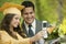 Graduate and father taking picture with cell phone outside