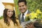 Graduate With Flowers And Father Outside