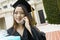 Graduate with Gift Using Cell Phone outside