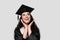 Graduate girl with master degree in black graduation gown and cap on white background. Happy young woman careerist have