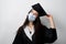 Graduate girl in medical mask at coronavirus covid-19 period. Woman with master degree in black graduation gown and cap