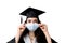 Graduate girl in medical mask at coronavirus covid-19 period. Woman with master degree in black graduation gown and cap