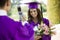 Graduate Having Picture Taken with Cell Phone