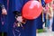 The graduate holds bell in her hand as a symbol of the last bell. Graduation day