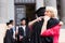 Graduate hugging mother