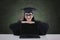 A graduate student with blank screen laptop