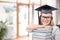 Graduate student girl in bachelor hat with books