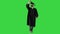 Graduate student walking and tossing up his hat on a Green Screen, Chroma Key.