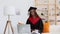 Graduate woman wear cap and gown and have online distant family meeting Spbi. proud afro female celebrating