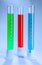 Graduated cylinders with different liquids on light background