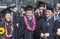 Graduates march across the stadium field