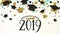 Graduation background class of 2019 with graduate cap, black and gold color, glitter dots on a white golden line striped