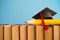 Graduation cap and big pencil over the books on blue wall background - Education concept