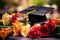 Graduation cap and diploma amidst vibrant roses