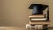 Graduation cap resting on book stack, atop wooden table