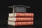 Graduation cap and Stack of dictionaries