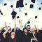 Graduation Caps Thrown Happiness Success Concept