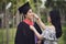 Graduation ceremony. Young female graduate hugging each other with her friend congratulate the student at the university