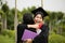 Graduation ceremony. Young female graduate hugging each other with her friend congratulate the student at the university