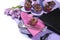 Graduation day pink and purple party table setting with cupcakes