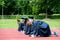 Graduation group of students celebrating on athletic track, prep