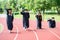 Graduation group of students celebrating on athletic track, prep