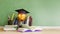 Graduation hat with golden trophy on wood table. 3D render