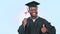 Graduation, thumbs up and man or student success, celebration and education, college diploma or university in studio