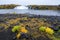 Grafarlandsfoss falls amidst autumn vegetation and black lava fields, Iceland.