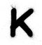 Graffiti small fat K font sprayed in black over white