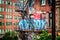 Graffiti and stairs on the side of a brick building seen from th