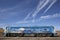 Graffiti on a train with railroad and blue sky.