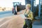 Grain being stored in granary or storage house with farmer keeping track