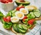 Grain bread sandwiches for breakfast, snacks toasts avocados, eggs, tomatoes, cucumbers. Keto diet. Healthy eating and food,