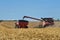 Grain cart being loaded from a combine harvester in  northern Illinois