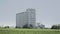 Grain concrete silo building in landscape, big seed elevator, agriculture countryside