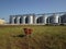 Grain elevator. Metal grain elevator in agricultural zone. Agriculture storage for harvest. Grain elevators on green