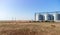 Grain elevator. Metal grain elevator in agricultural zone. Agriculture storage for harvest. Grain elevators on green