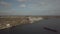 Grain elevator in the port on the river bank. Huge stainless steel tanks for storing crops. Aerial drone or quadrocopter aerial vi