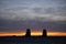 Grain elevators silhouetted against a winter sunset