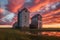 grain elevators at sunset with dramatic sky