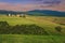 Grain fields and Vitaleta chapel on the hill, Tuscany, Italy