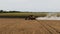 Grain harvester at work. Combine harvester with straw chopper works in the wheat field. Harvesting Wheat in slow motion