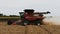 Grain harvester at work. Combine harvester with straw chopper works in the wheat field. Harvesting Wheat in slow motion