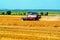 Grain harvesting combines work in wheat field